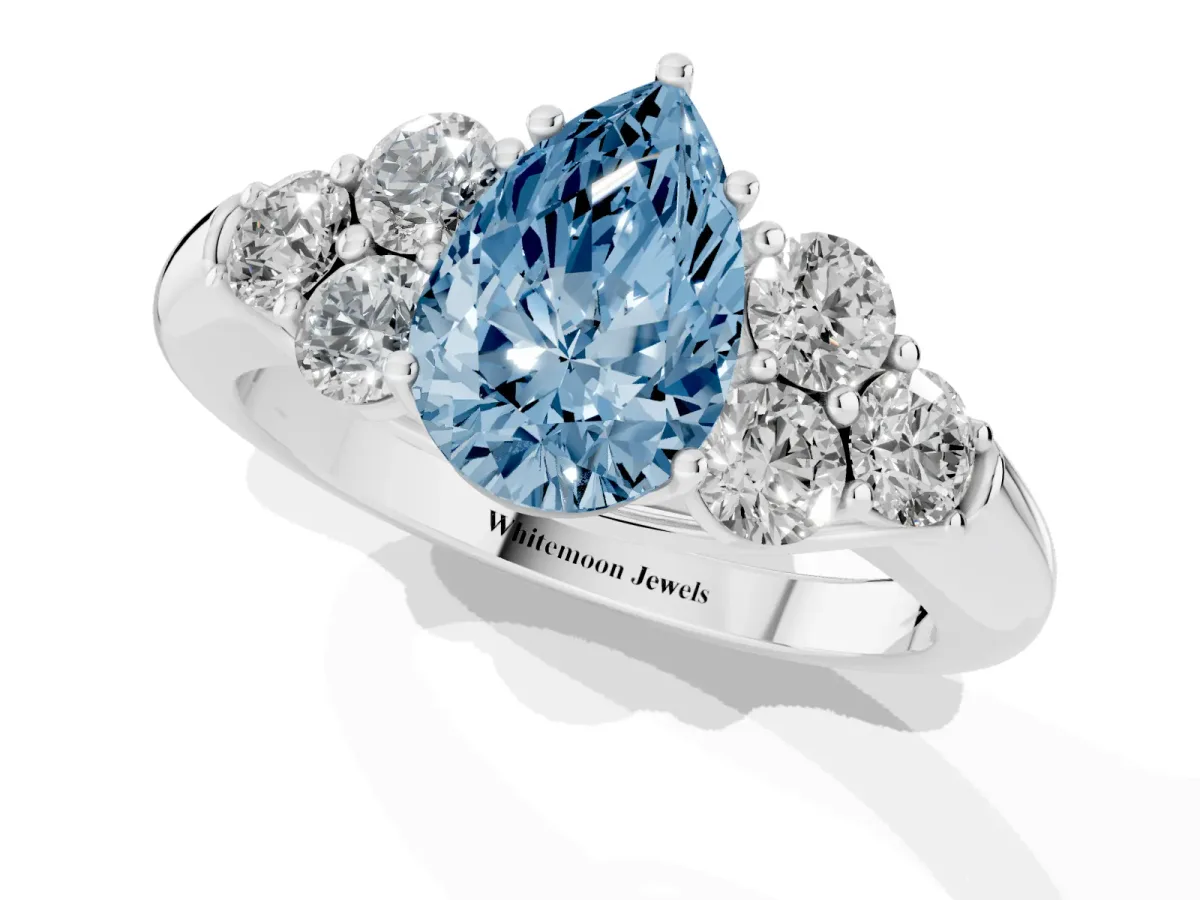 Fancy Blue Pear Cut Cut Diamond Cluster Ring with Round Accent Stones and Prong Setting on a Classic Band White gold