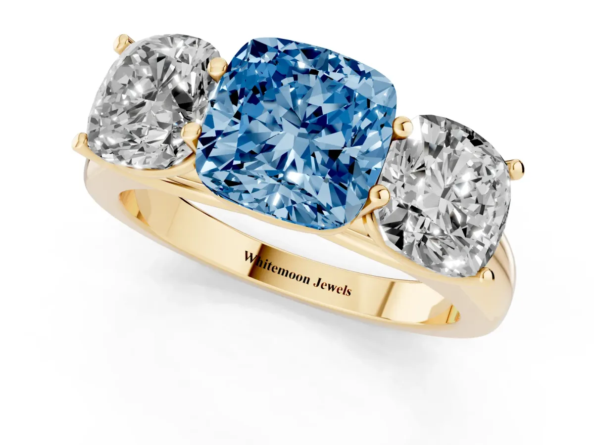 Fancy Blue Cushion Cut Three-Stone Diamond Ring with Prong Setting on a Classic Band Yellow gold