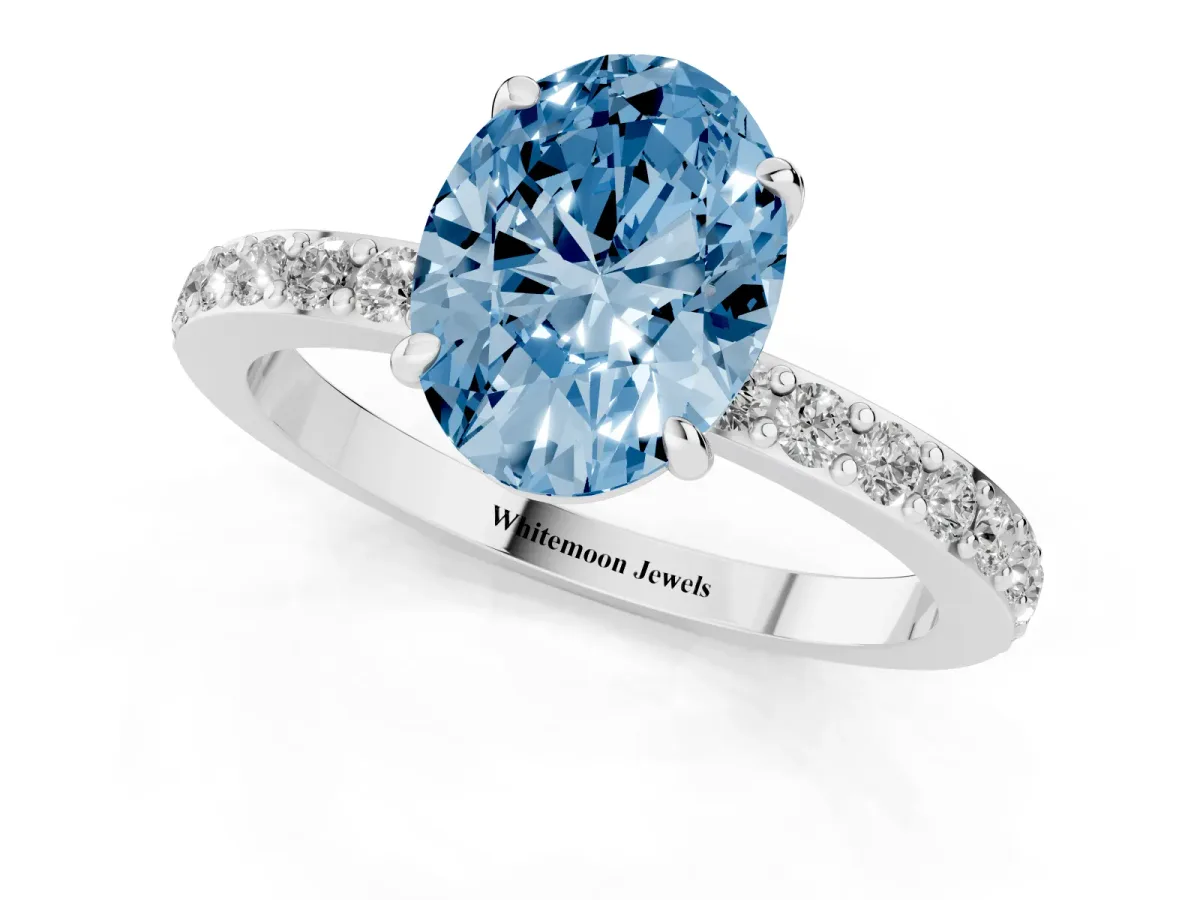 Fancy Blue Oval Cut Diamond Pavé Engagement Ring with Round Accents and Prong Setting Platinum