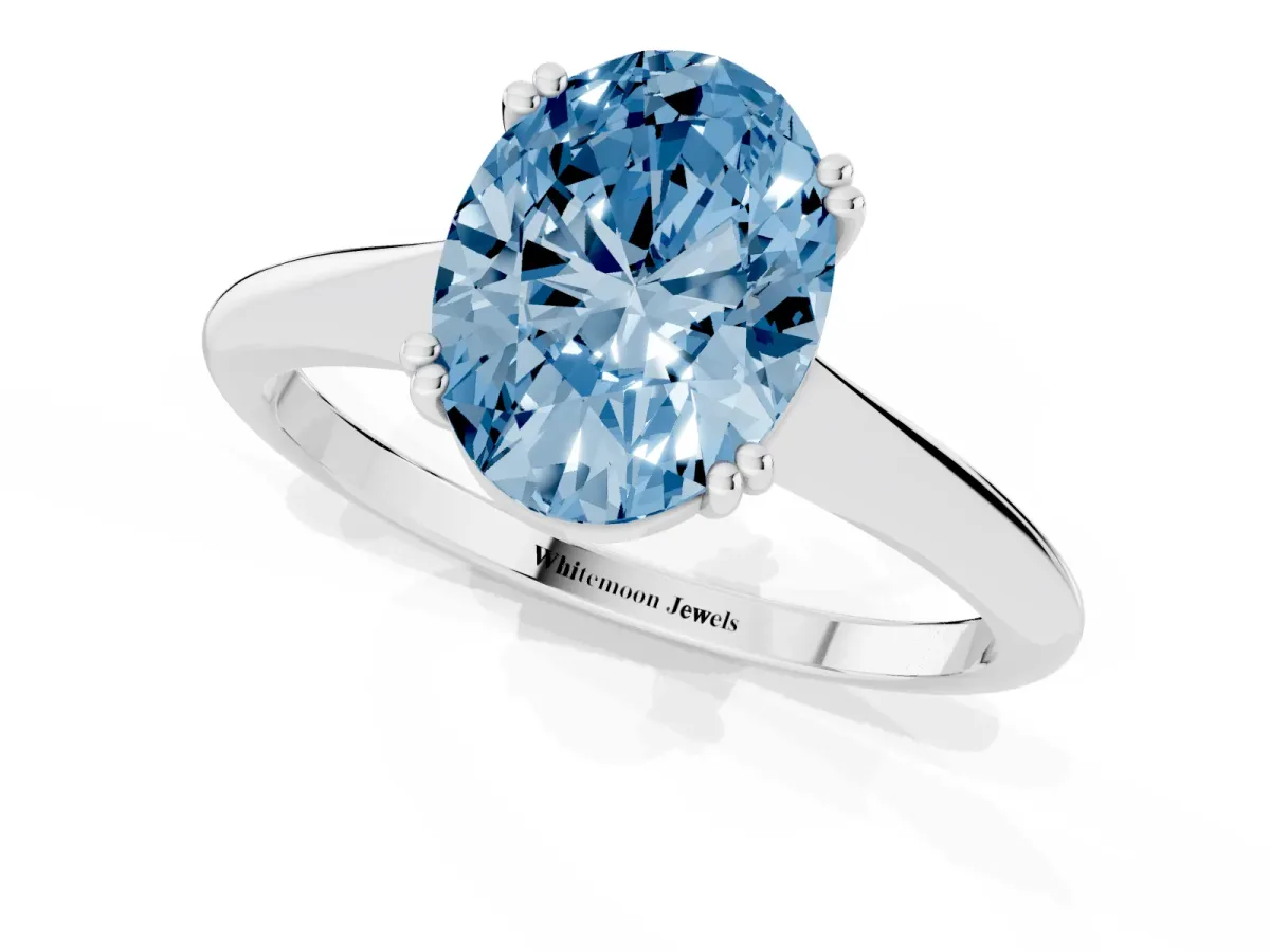 Fancy Blue Oval Cut Solitaire Diamond Ring with Six-Prong Setting and Classic Band Silver