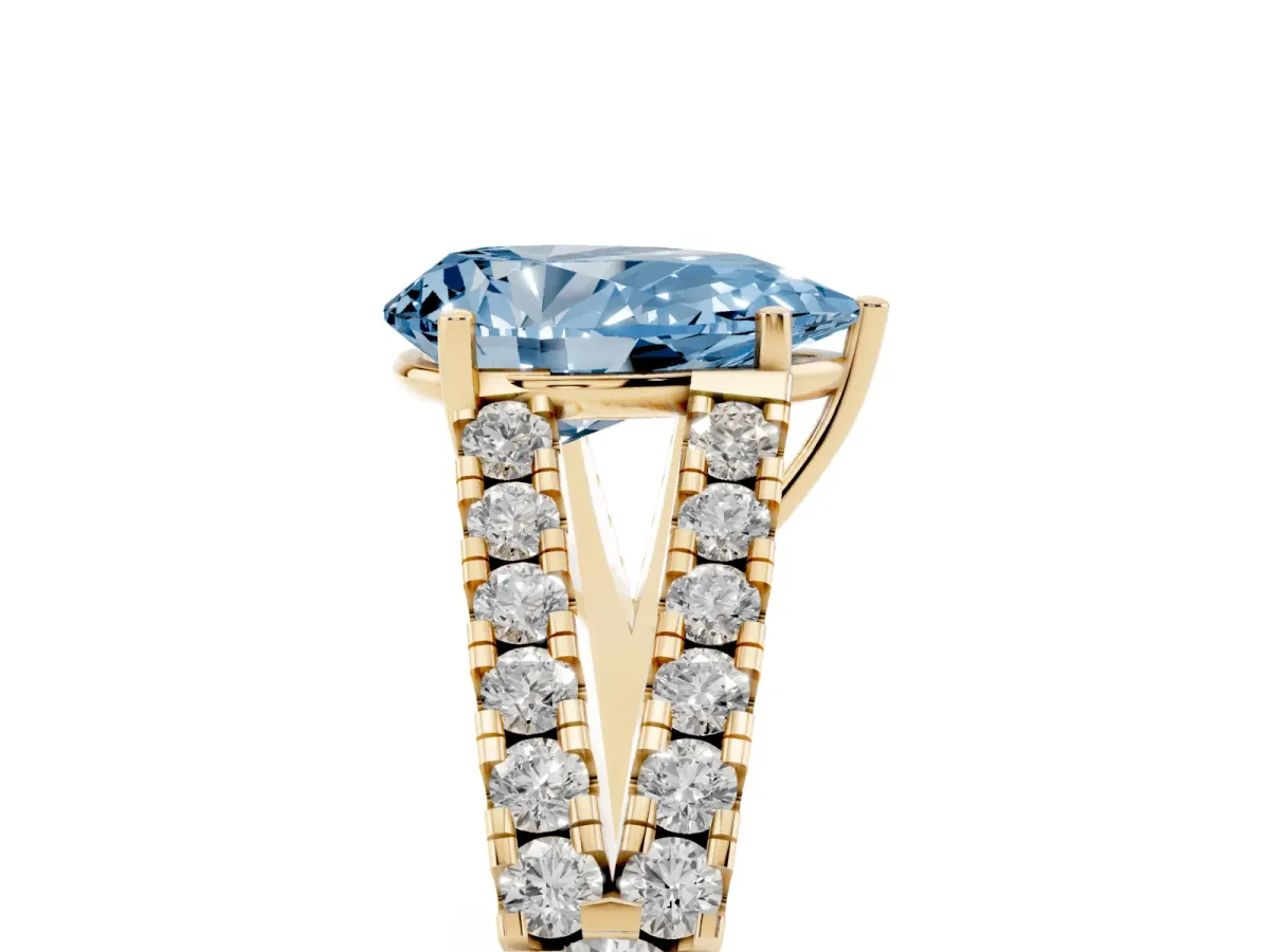 Fancy Blue Pear Cut Diamond Split Shank Engagement Ring with Round Pavé and Prong Setting Yellow gold