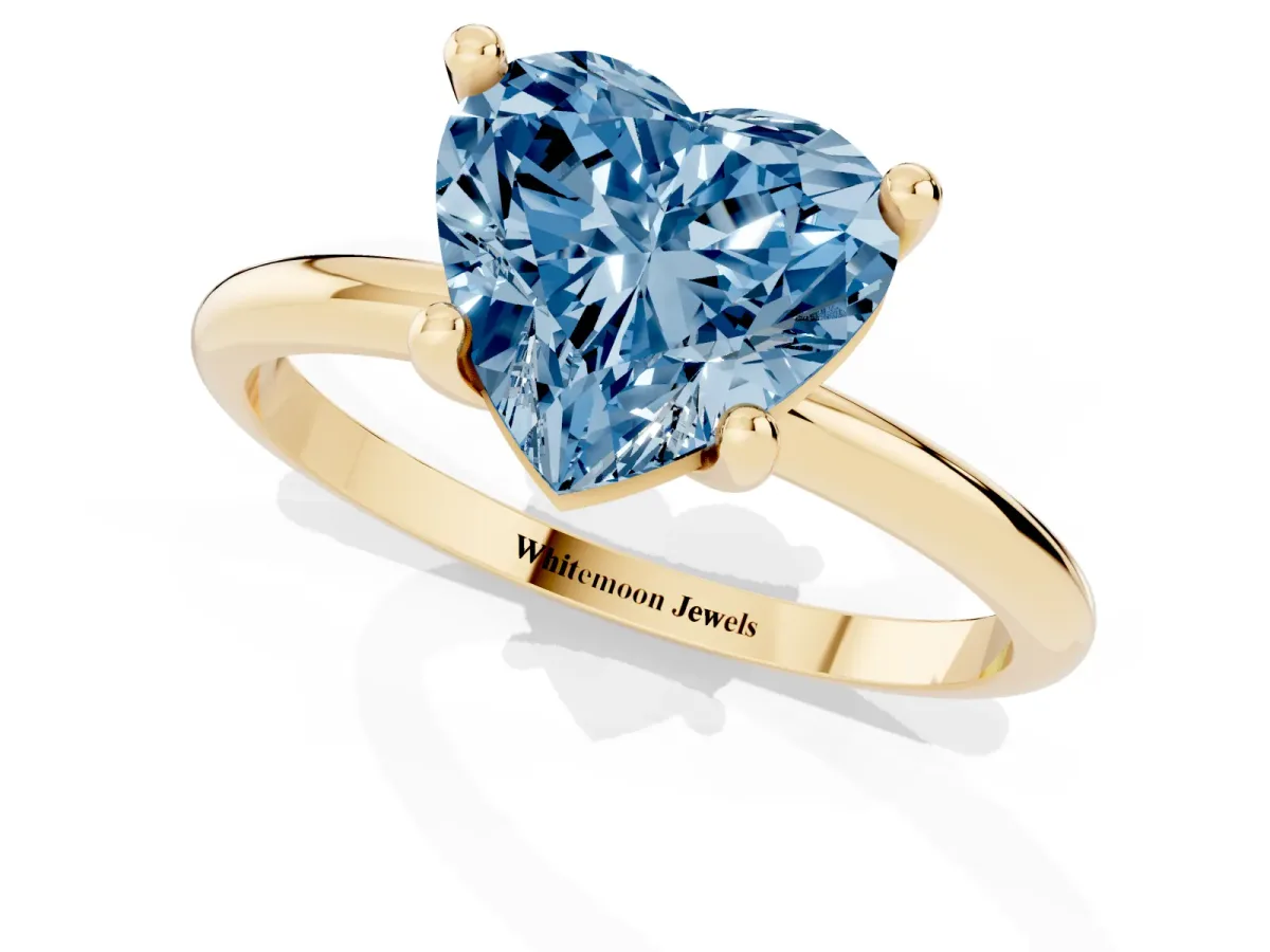 Fancy Blue Heart Cut Solitaire Diamond Ring with 4-Prong Setting on a Classic Band Yellow gold