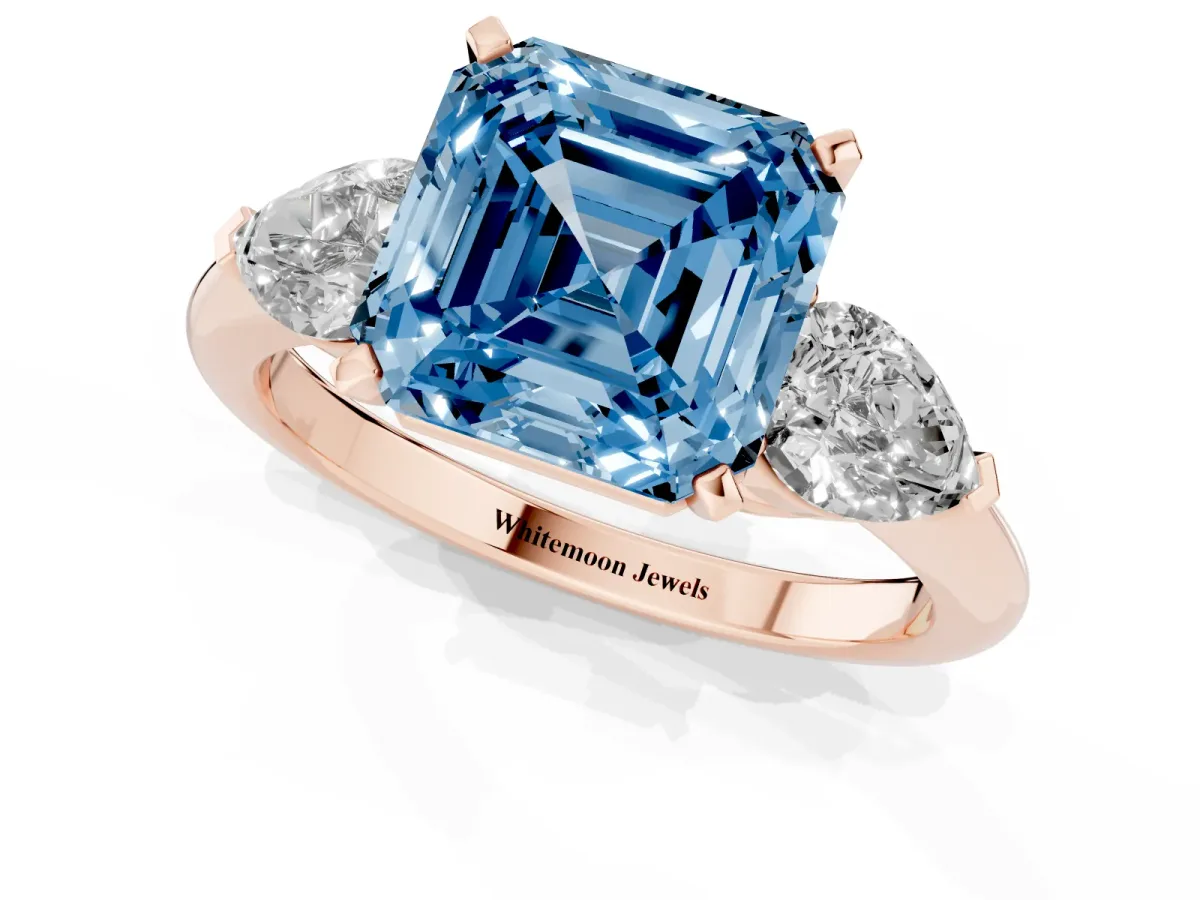 Fancy Blue Three-Stone Asscher Cut Diamond Ring with Pear Side Stones and Four-Prong Setting Rose gold