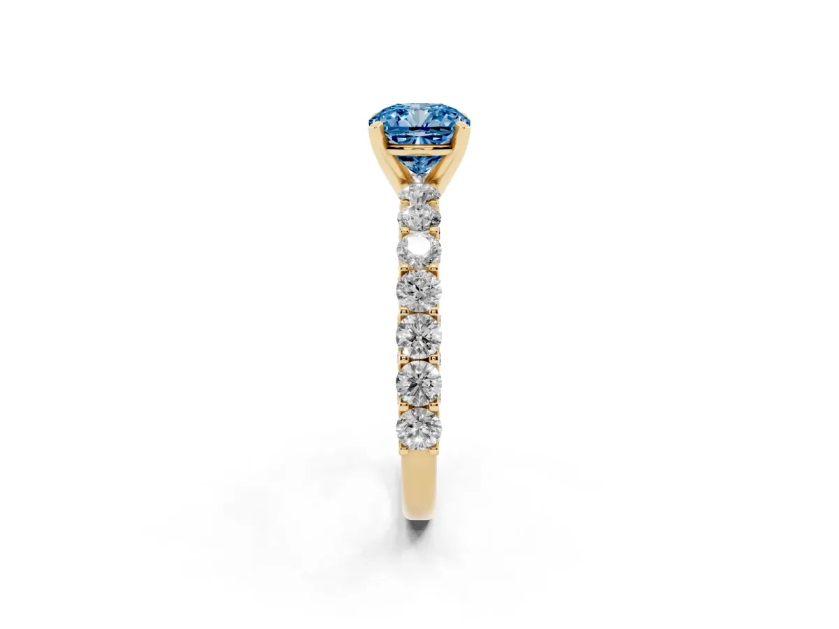 Fancy Blue Cushion Cut Diamond Solitaire Ring with Shared Prong Pavé Band and Four-Prong Setting Yellow gold