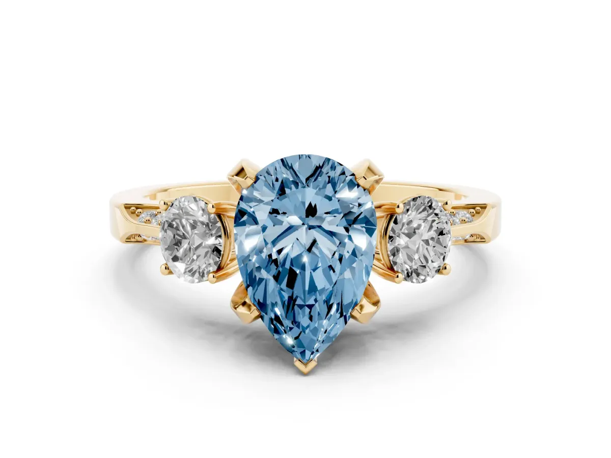 Fancy Blue Pear Cut Brilliant Three-Stone Diamond Ring with Pavé Band and Four-Prong Setting Yellow gold