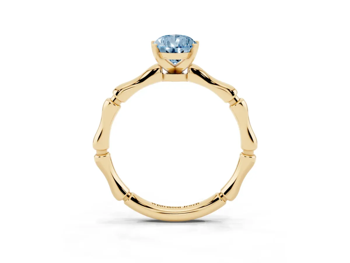 Fancy Blue Pear Cut Solitaire Diamond Ring with Bamboo Band and Four-Prong Setting Yellow gold