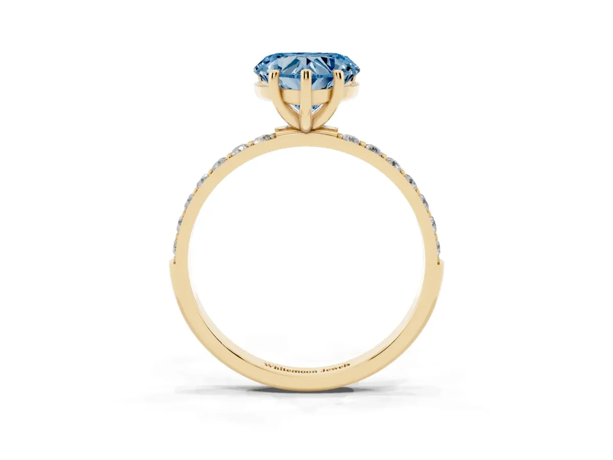 Fancy Blue Heart Cut Diamond Solitaire Ring with Round Pavé Shoulders and Prong Setting Yellow gold