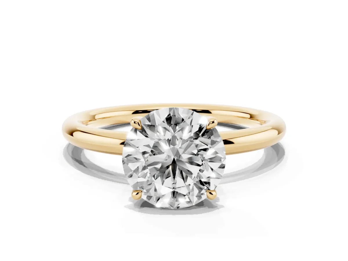 Round Cut Diamond Solitaire Ring with Thin Band and Four-Prong Setting Yellow gold