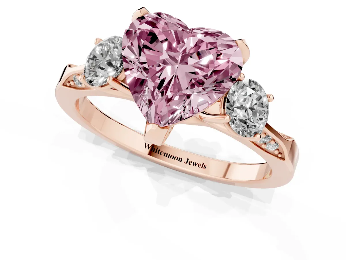 Fancy Pink Heart Cut Brilliant Three-Stone Diamond Ring with Pavé Band and Four-Prong Setting Rose gold