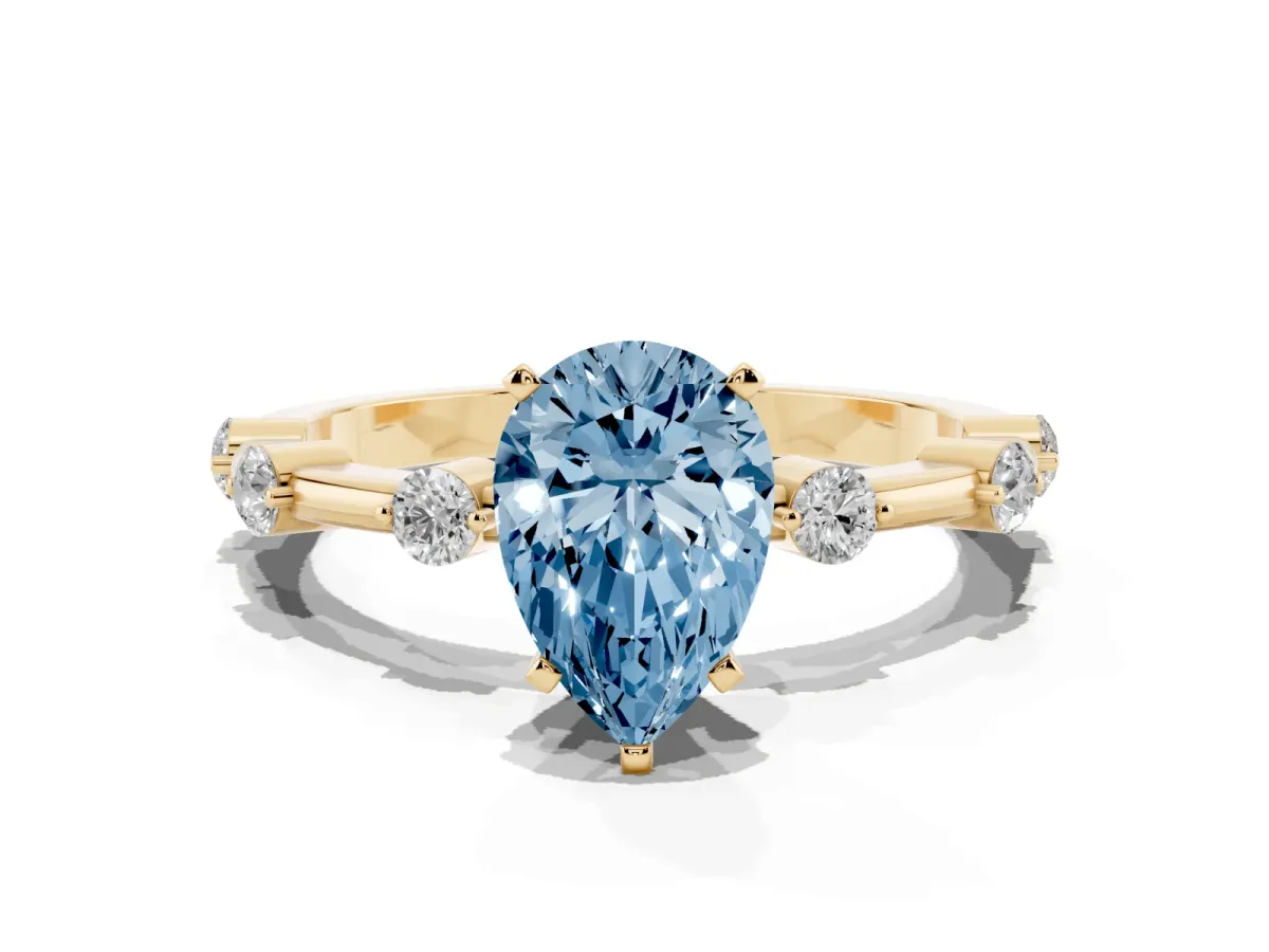 Fancy Blue Pear Cut Solitaire Diamond Ring with Bezel Set Side Stones and Prong Setting Yellow gold