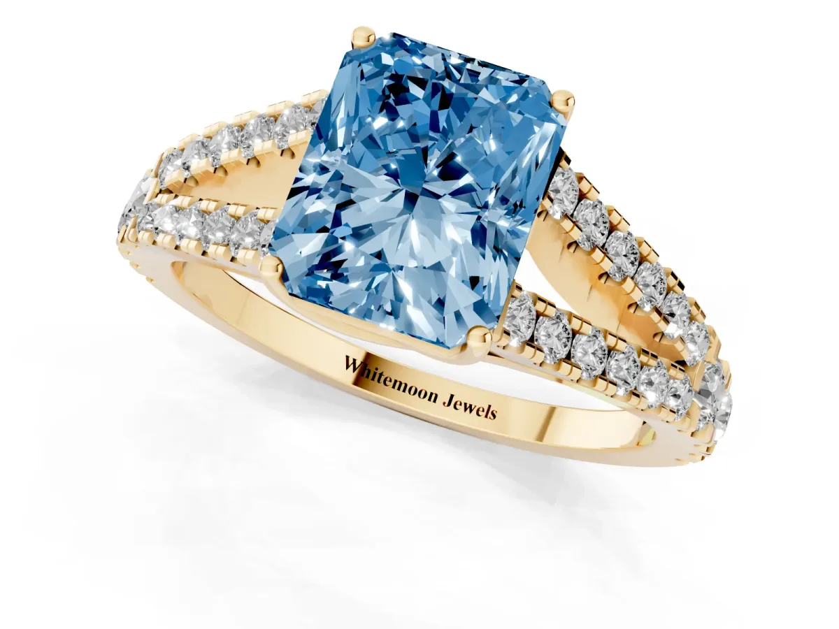 Fancy Blue Radiant Cut Diamond Split Shank Pavé Engagement Ring with Four-Prong Setting Yellow gold