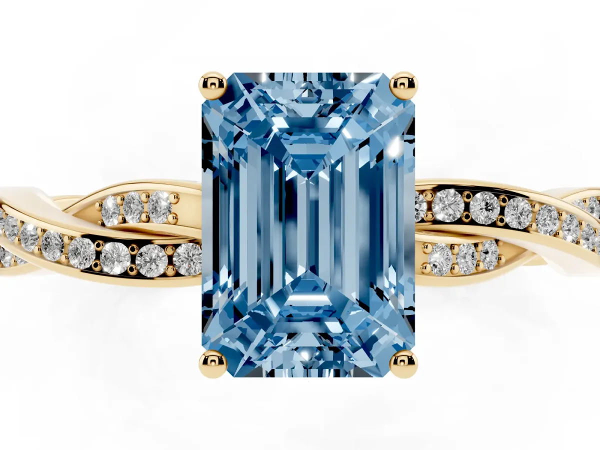 Fancy Blue Emerald Cut Solitaire Twisted Pave Diamond Ring with Four-Prong Setting Yellow gold