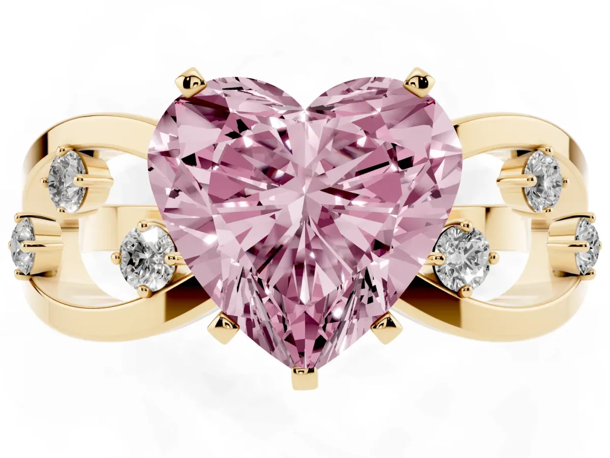 Fancy Pink Heart Cut Cut Solitaire Diamond with Side Stones on Criss-Cross Band and Four-Prong Setting Yellow gold
