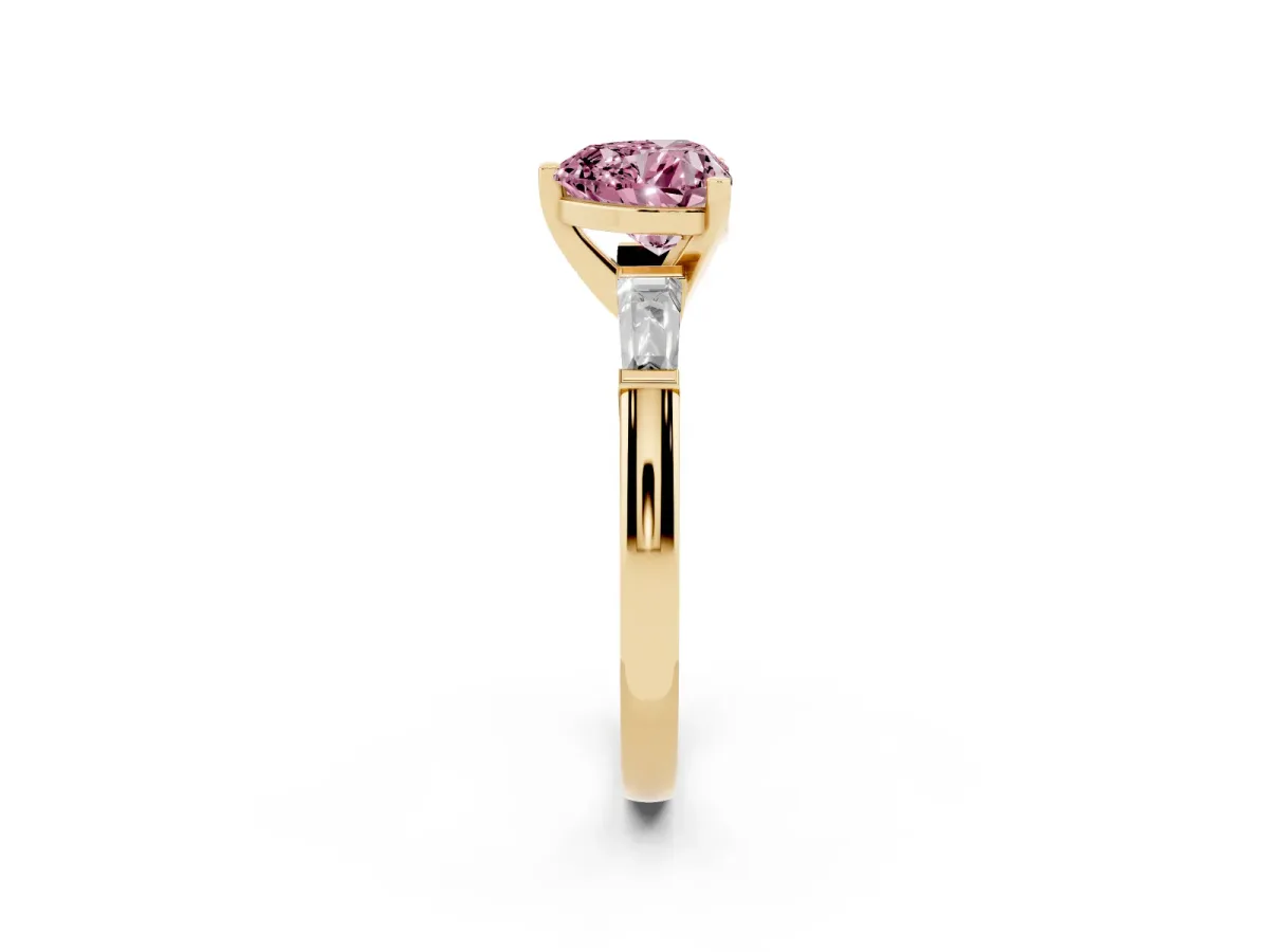 Fancy Pink Heart Cut Solitaire with Tapered Baguette Side Stones on a Classic Band with Four-Prong Setting Yellow gold