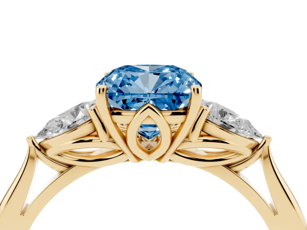 Fancy Blue Three-Stone Cushion Cut Diamond Ring with Pear Side Stones in Four-Prong Setting Yellow gold