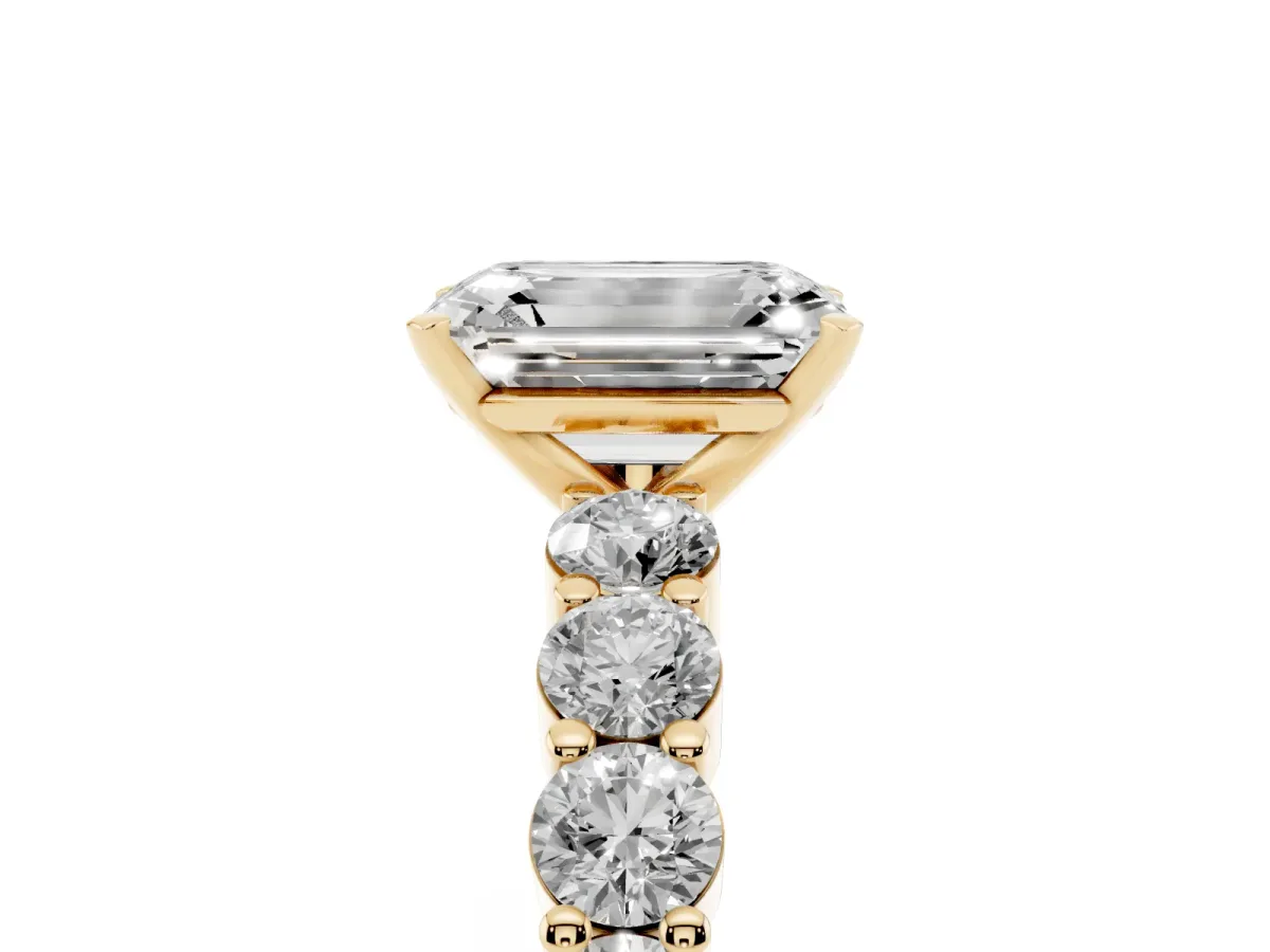 Emerald Cut Diamond Solitaire Ring with Shared Prong Round Side Stones Yellow gold