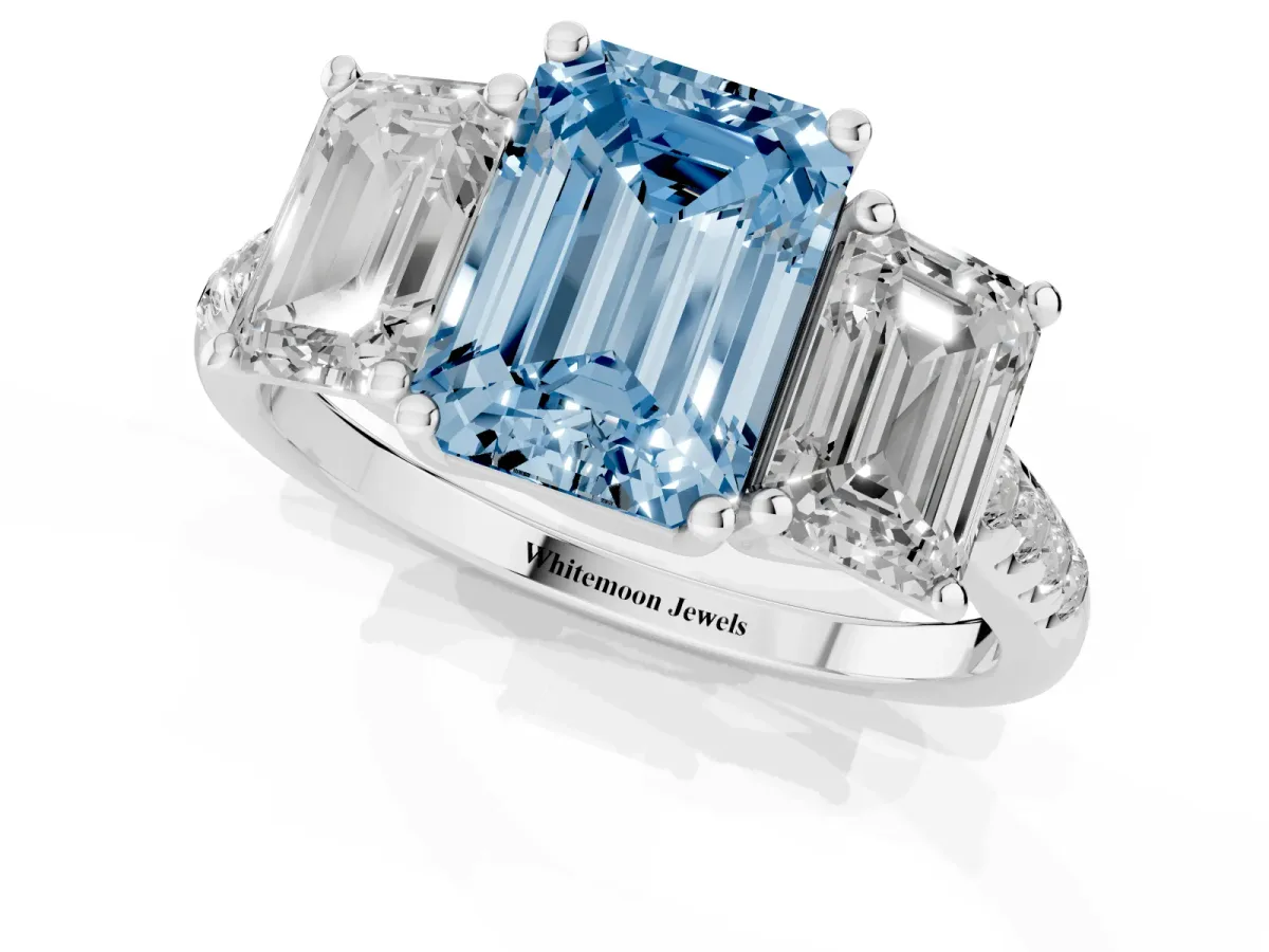 Fancy Blue Three-Stone Emerald Cut Diamond Ring with Round Pavé Band and Prong Setting Silver