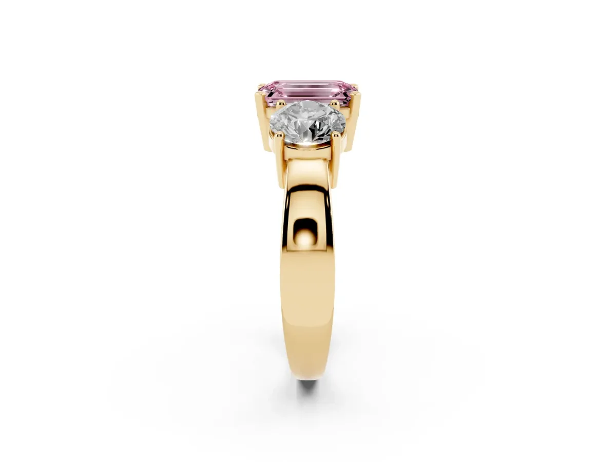 Fancy Pink Three-Stone Emerald Cut Diamond Ring with Round Side Stones, Classic Band, and Four-Prong Setting Yellow gold