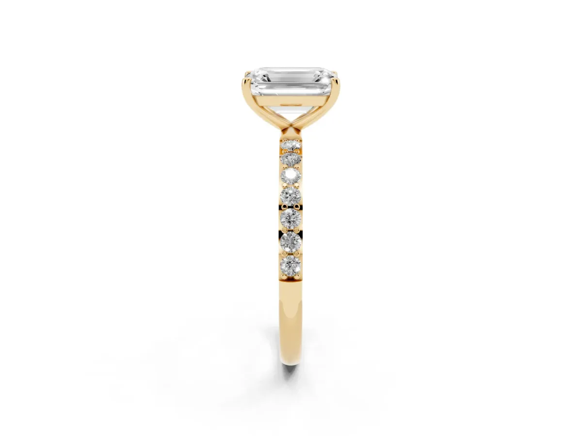 Emerald Cut Diamond Solitaire Ring with Round Pavé Shoulders and Prong Setting Yellow gold
