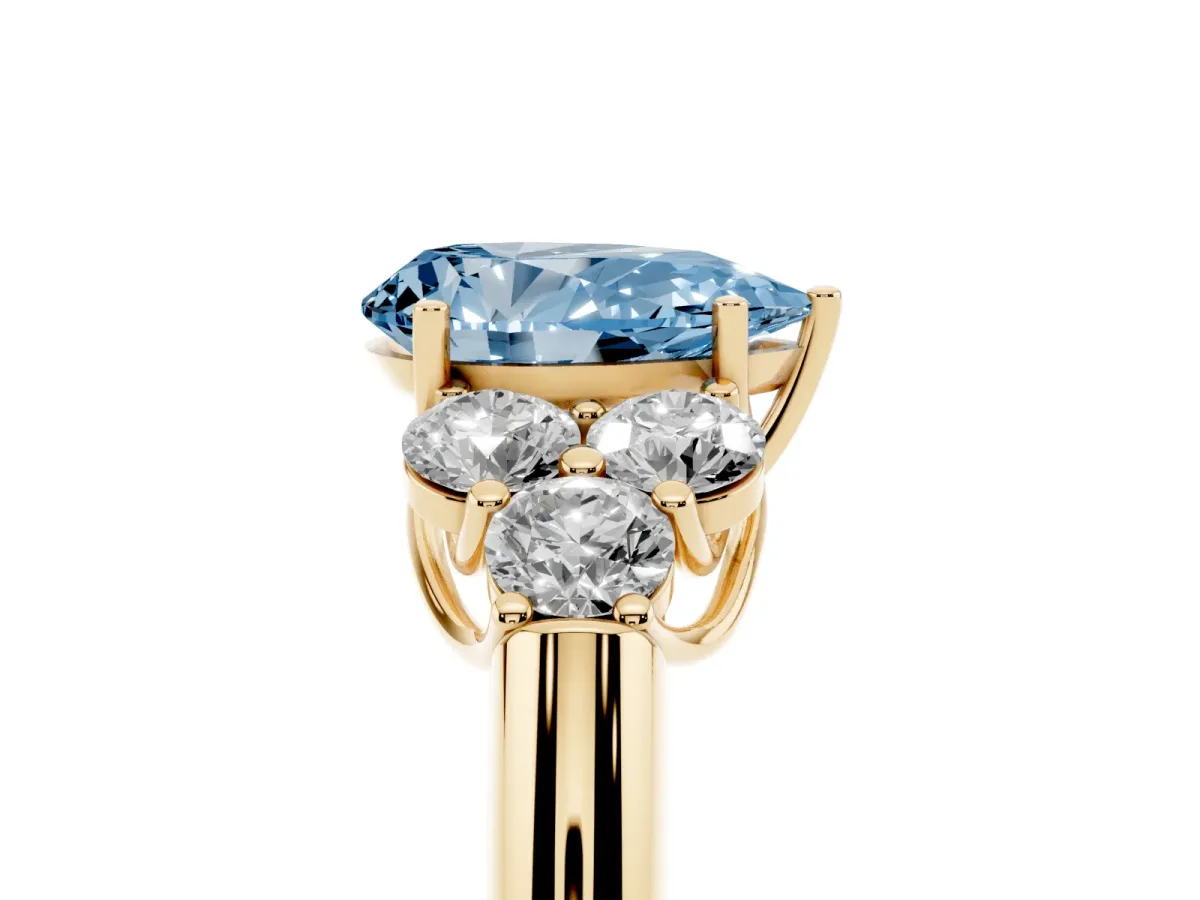 Fancy Blue Pear Cut Cut Diamond Cluster Ring with Round Accent Stones and Prong Setting on a Classic Band Yellow gold