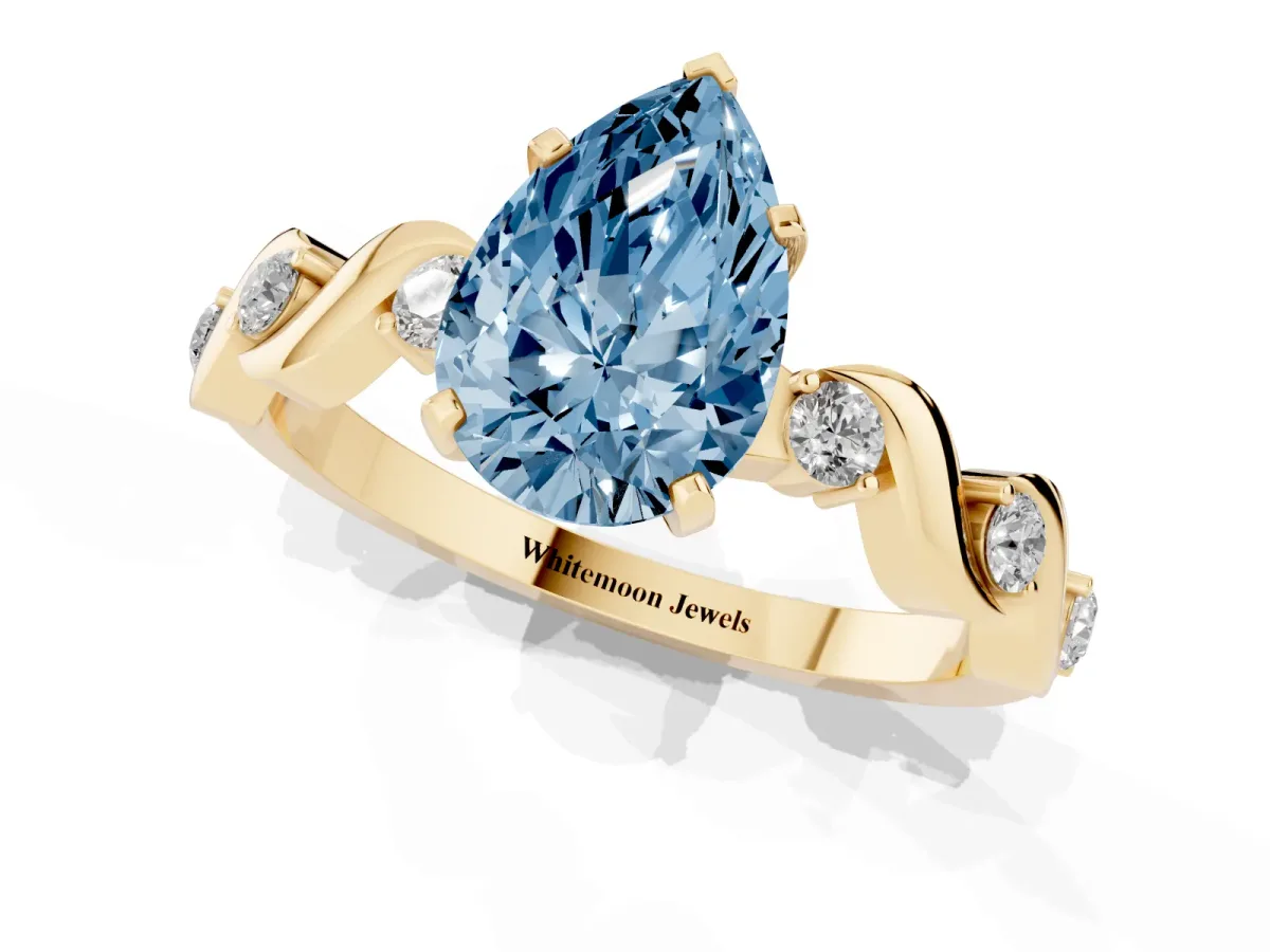 Fancy Blue Pear Cut Diamond Solitaire Twisted Band with Round Accents and Prong Setting Yellow gold