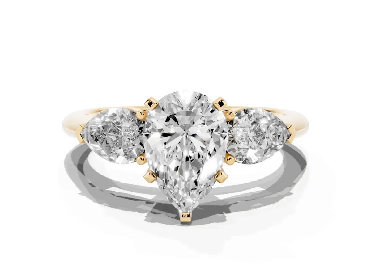 Three-Stone Pear Cut Diamond Ring with Pear Side Stones and Four-Prong Setting Yellow gold