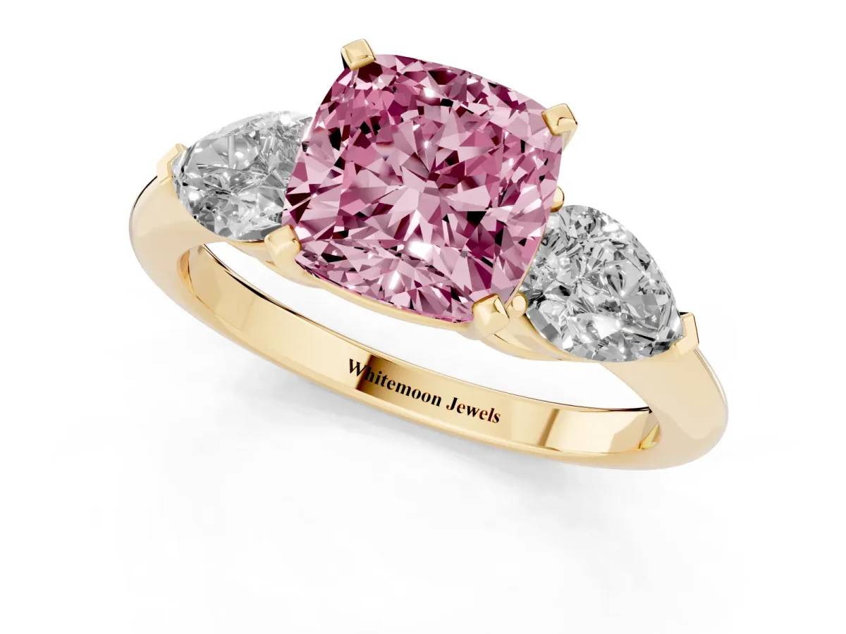 Fancy Pink Three-Stone Cushion Cut Diamond Ring with Pear Side Stones and Four-Prong Setting Yellow gold