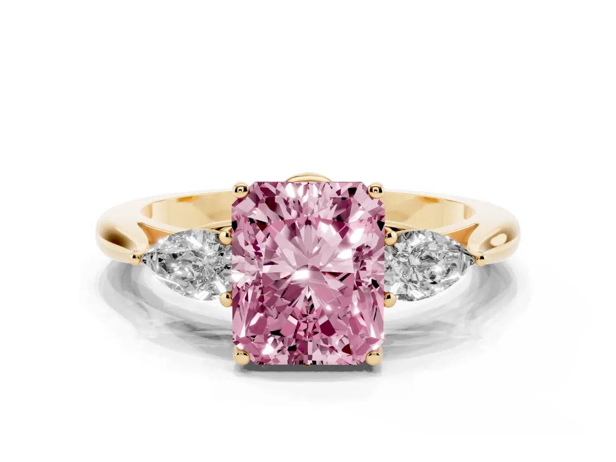 Fancy Pink Three-Stone Radiant Cut Diamond Ring with Pear Side Stones in Four-Prong Setting Yellow gold