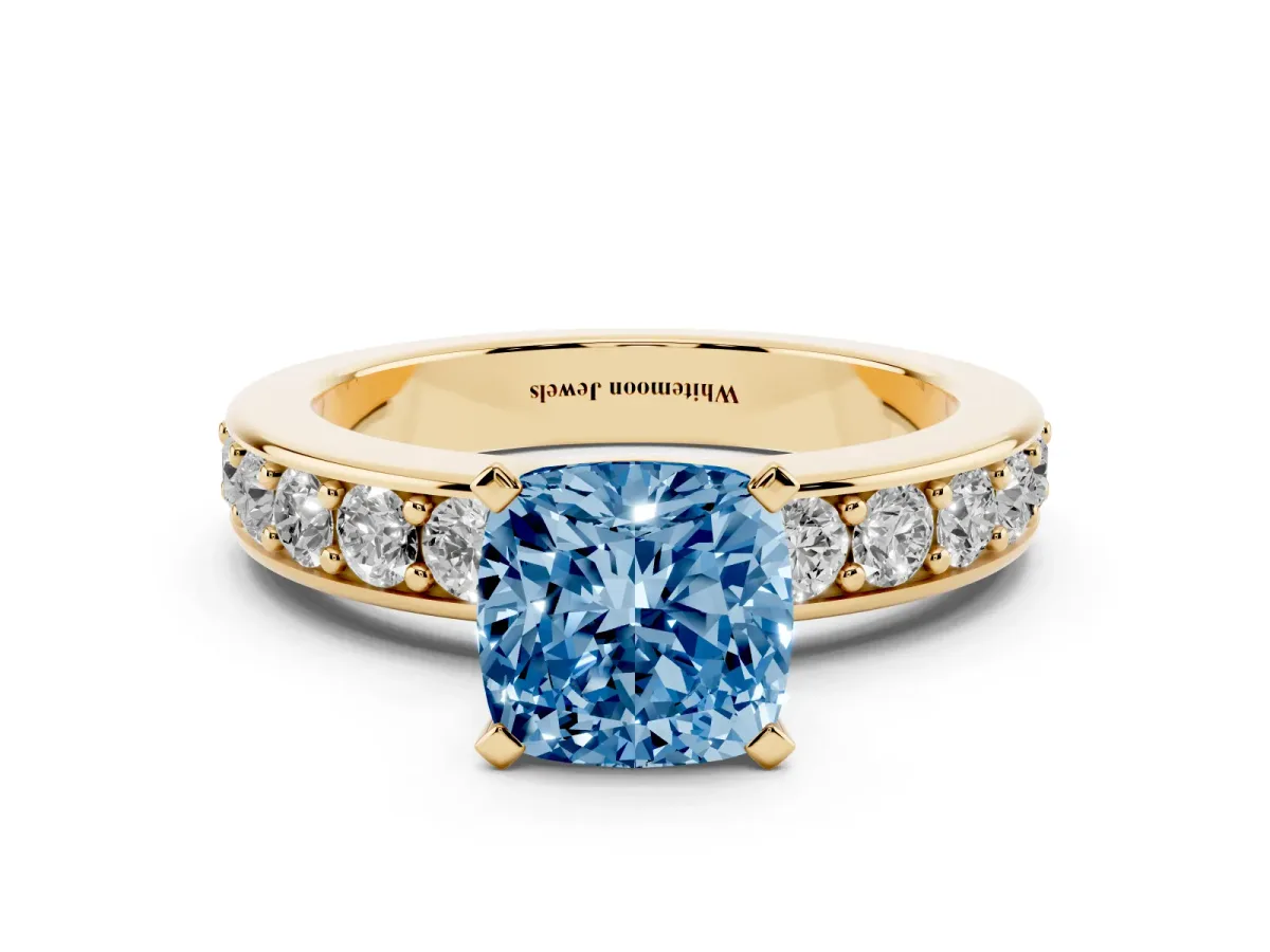 Fancy Blue Cushion Cut Diamond Engagement Ring with Channel Set Round Band and Prong Setting Yellow gold