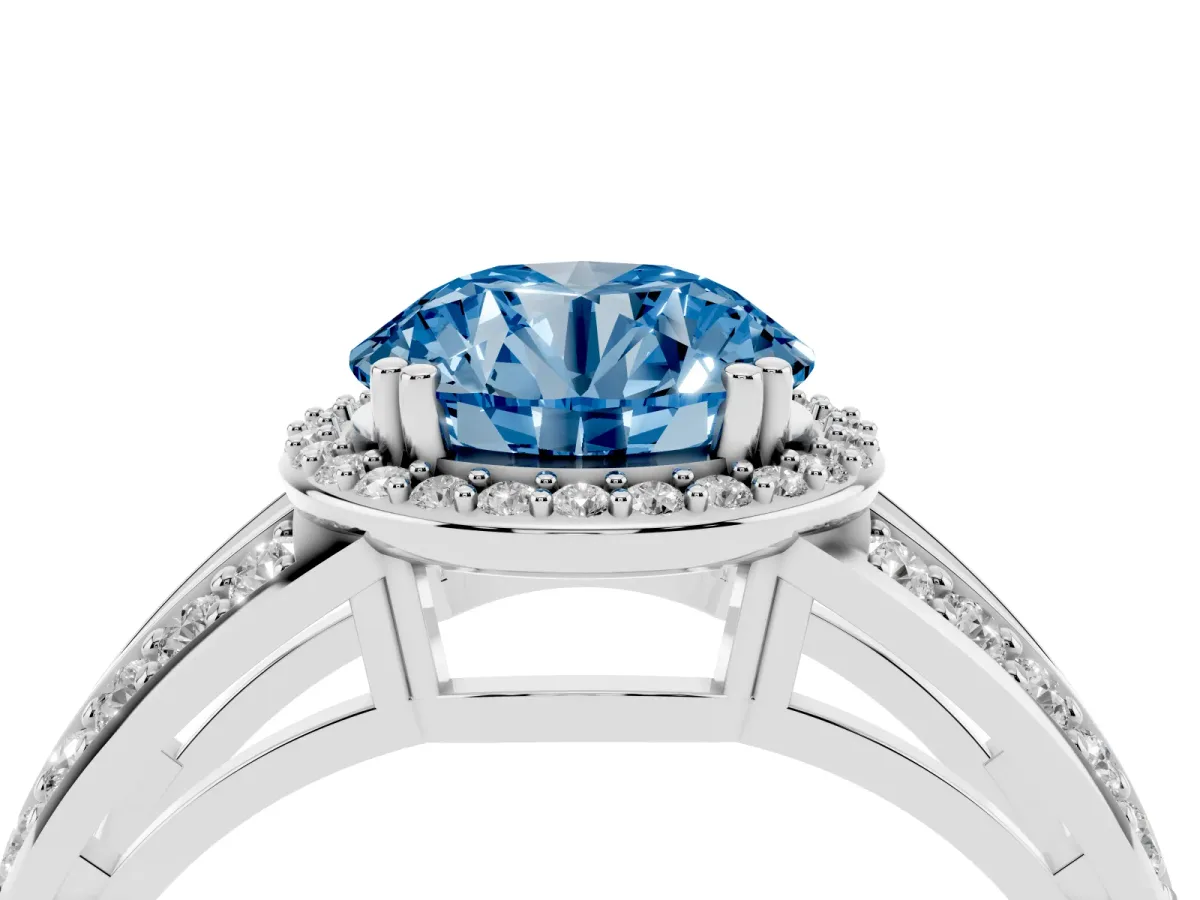 Fancy Blue Round Cut Diamond Halo Ring with Split Shank Pavé Band and Four-Prong Setting Silver