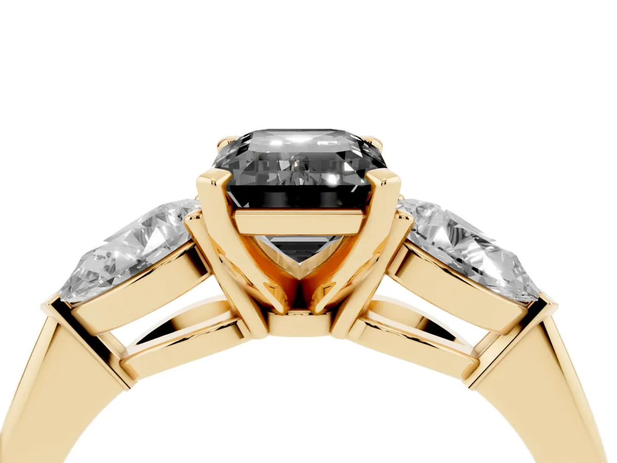 Fancy Black Three-Stone Emerald Cut Diamond Ring with Pear Side Stones and Four-Prong Setting Yellow gold