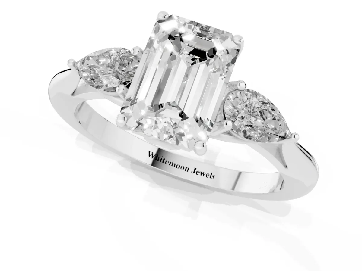 Three-Stone Emerald Cut Diamond Ring with Pear Side Stones in Four-Prong Setting Platinum