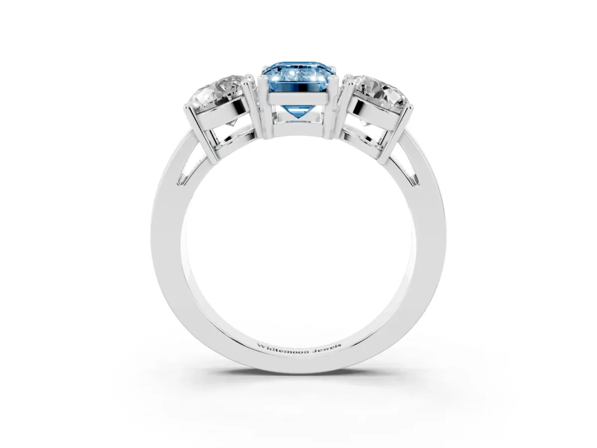 Fancy Blue Three-Stone Emerald Cut Diamond Ring with Round Side Stones, Classic Band, and Four-Prong Setting Silver