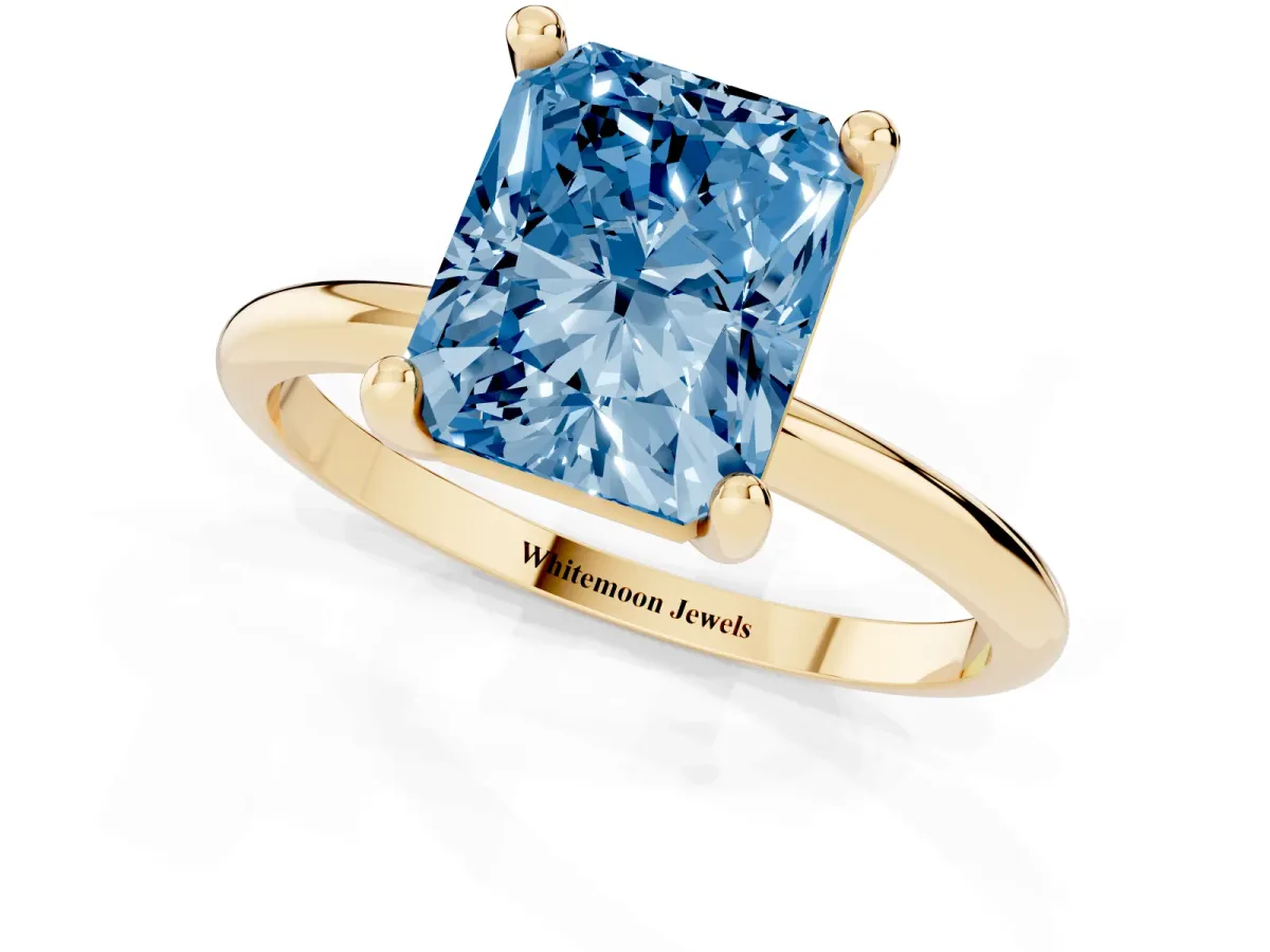 Fancy Blue Radiant Cut Solitaire Diamond Ring with 4-Prong Setting on a Classic Band Yellow gold