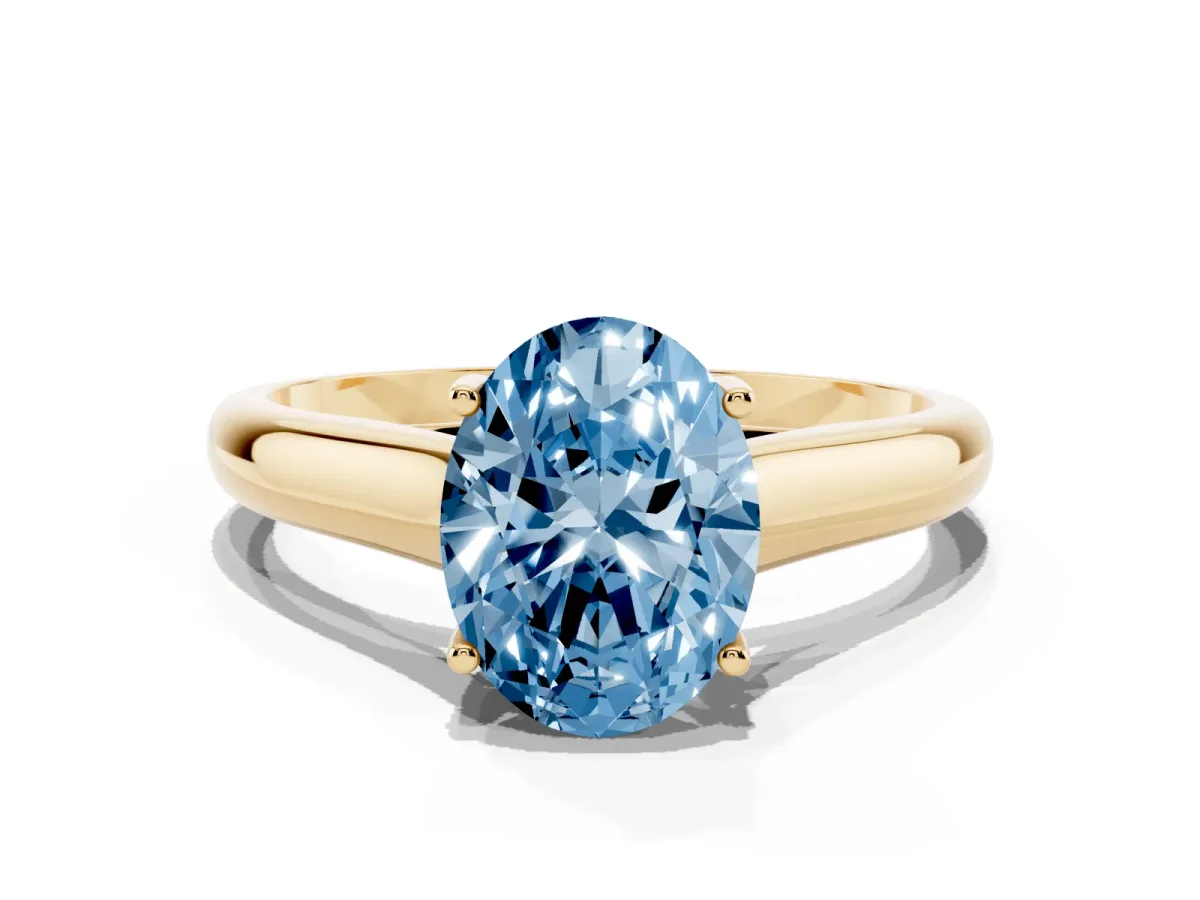Fancy Blue Oval Cut Solitaire Engagement Ring with Tapered Band and Four-Prong Setting Yellow gold