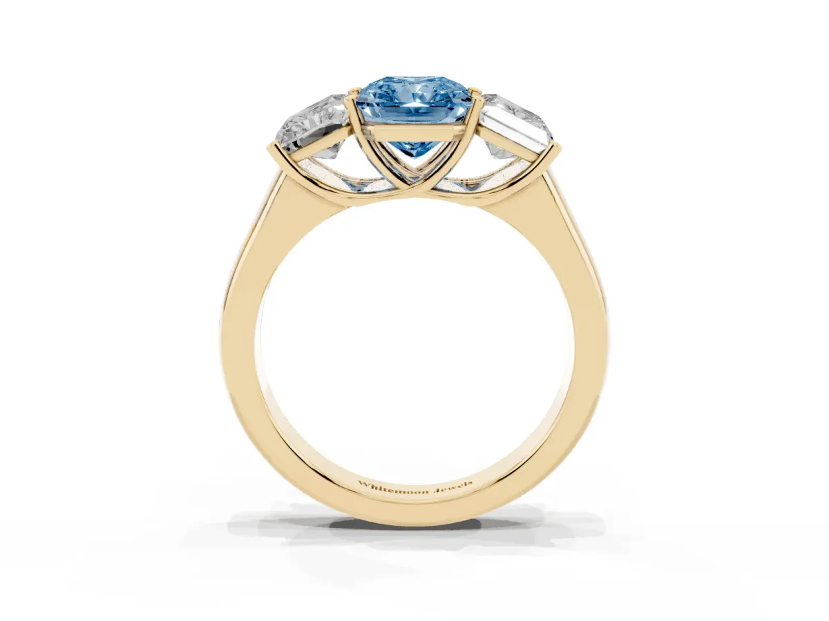 Fancy Blue Radiant Cut Three-Stone Diamond Ring with Prong Setting on a Classic Band Yellow gold