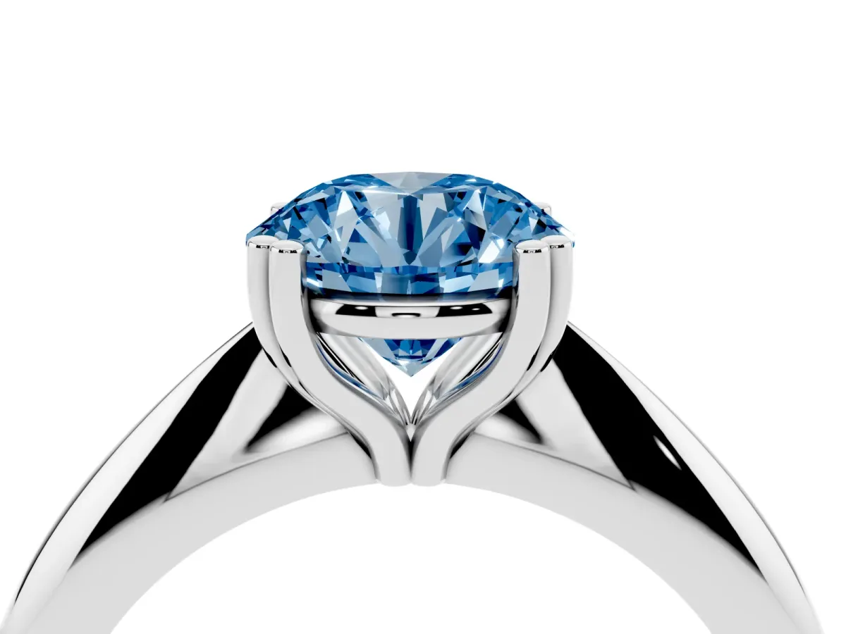 Fancy Blue Round Cut Cut Solitaire Engagement Ring with Tapered Band and Four-Prong Setting Silver