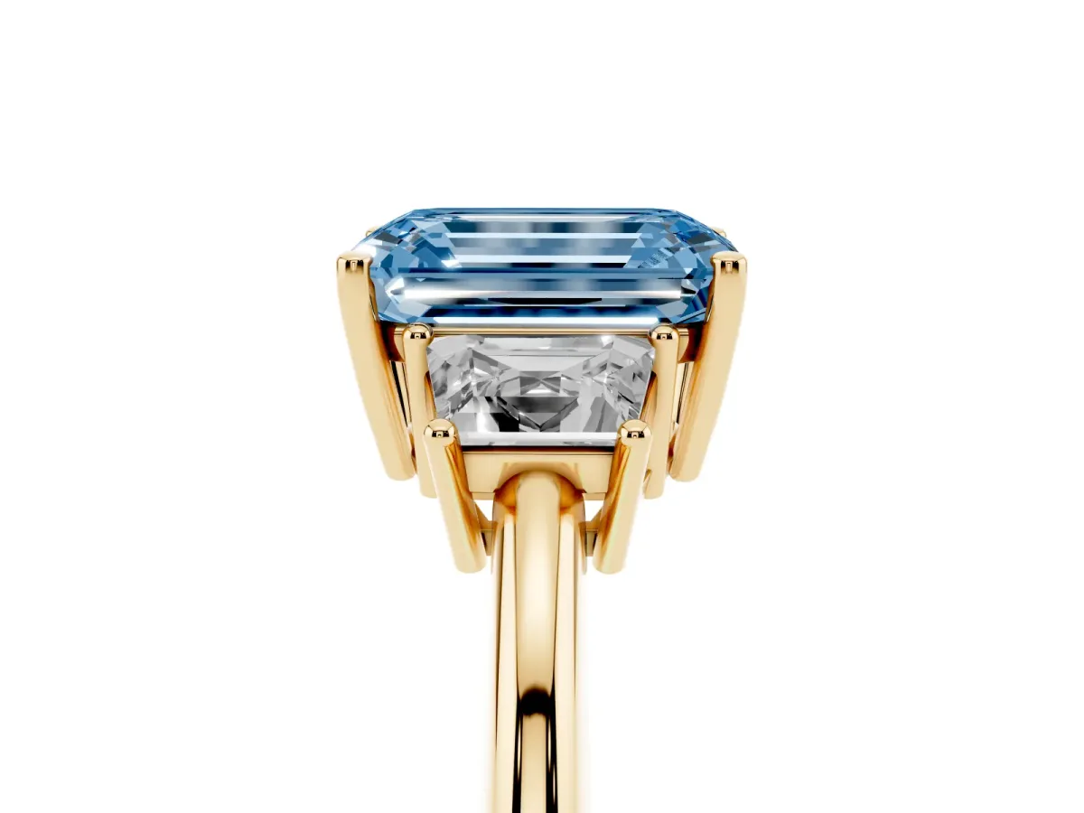Fancy Blue Emerald Cut Diamond Three-Stone Ring with Trapezoid Side Stones and Prong Setting Yellow gold