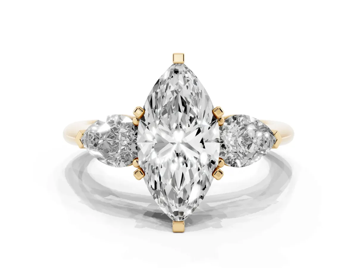 Three-Stone Marquise Cut Diamond Ring with Pear Side Stones and Four-Prong Setting Yellow gold