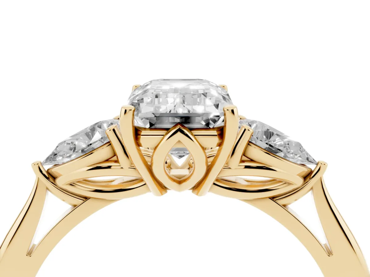 Three-Stone Emerald Cut Diamond Ring with Pear Side Stones in Four-Prong Setting Yellow gold