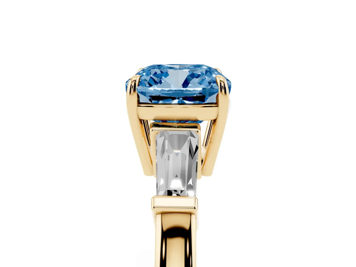 Fancy Blue Cushion Cut Diamond Three-Stone Ring with Tapered Baguette Side Stones and Prong Setting Yellow gold