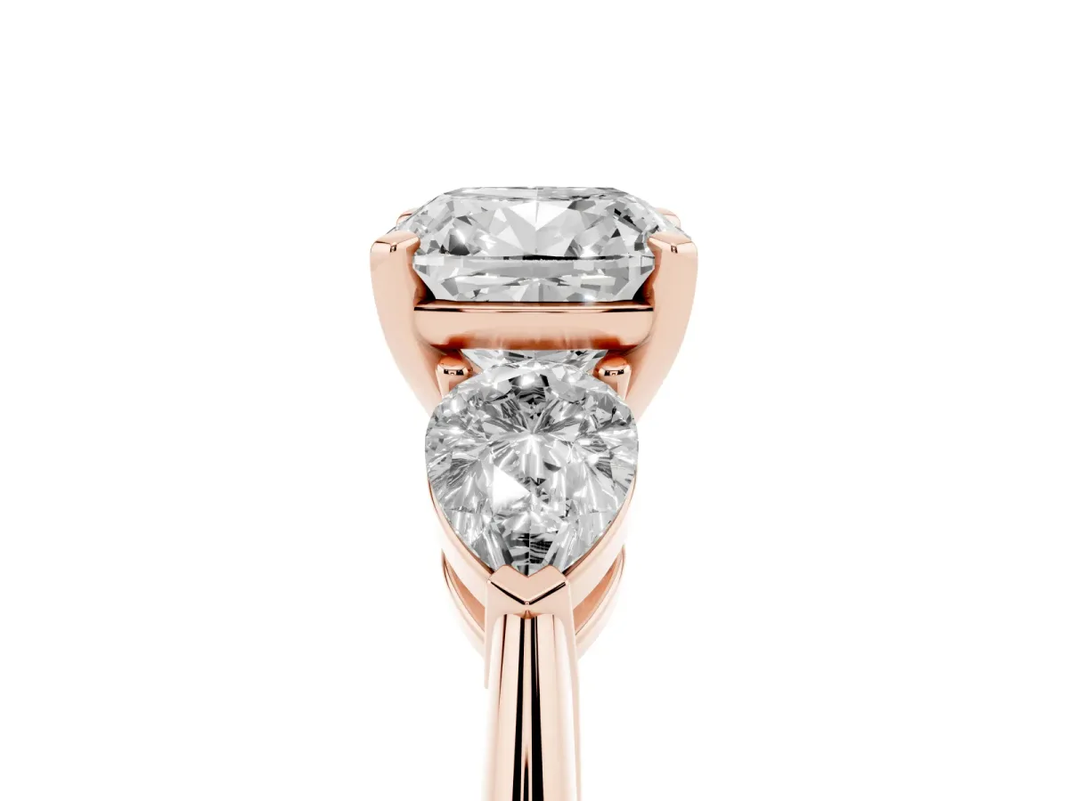 Three-Stone Cushion Cut Diamond Ring with Pear Side Stones and Four-Prong Setting Rose gold