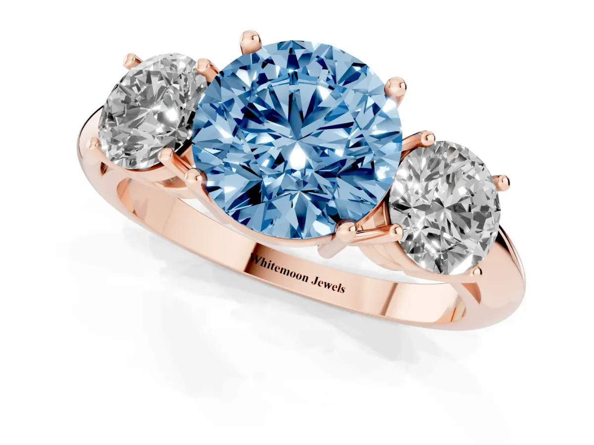 Fancy Blue Three-Stone Round Cut Cut Diamond Engagement Ring with Prong Setting on a White Gold Band Rose gold