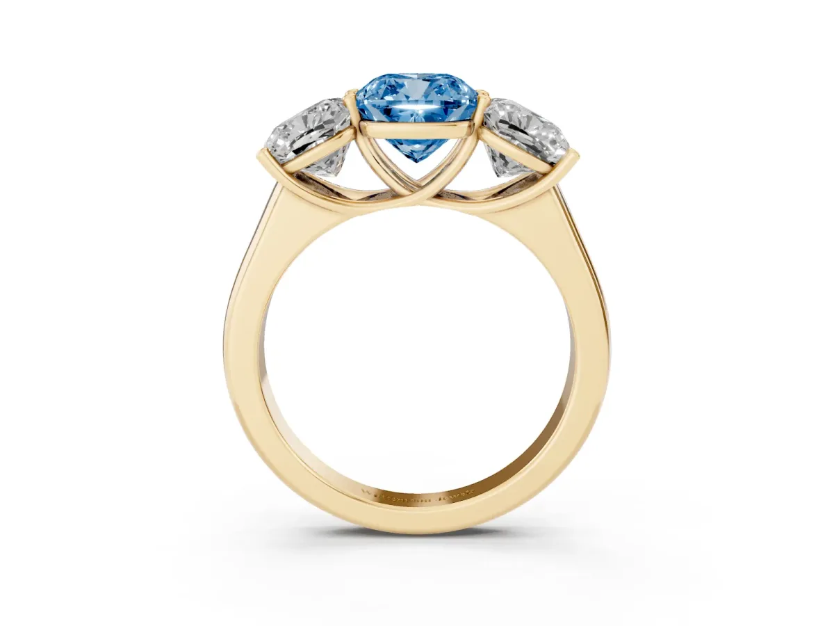 Fancy Blue Cushion Cut Three-Stone Diamond Ring with Prong Setting on a Classic Band Yellow gold