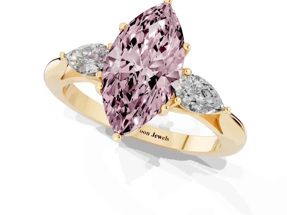 Fancy Pink Three-Stone Marquise Cut Diamond Ring with Pear Side Stones in Four-Prong Setting Yellow gold