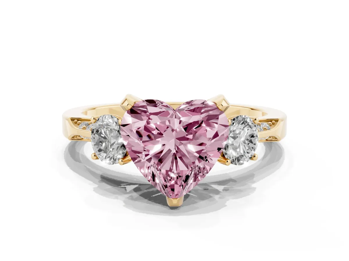 Fancy Pink Heart Cut Brilliant Three-Stone Diamond Ring with Pavé Band and Four-Prong Setting Yellow gold
