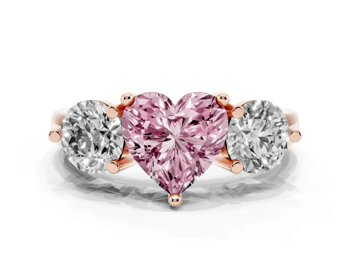 Fancy Pink Three-Stone Heart Cut Brilliant Cut Solitaire Ring with Prong Setting on a Classic Band Rose gold