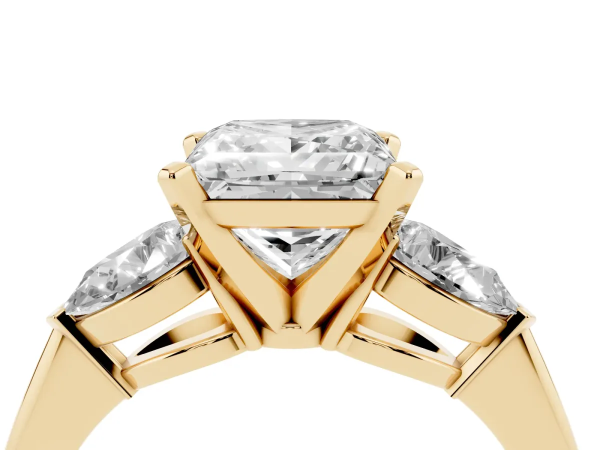 Three-Stone Princess Cut Diamond Ring with Pear Side Stones and Four-Prong Setting Yellow gold