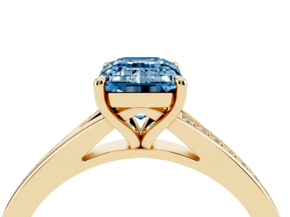 Fancy Blue Emerald Cut Diamond Solitaire Ring with Pavé Band and Prong Setting Yellow gold