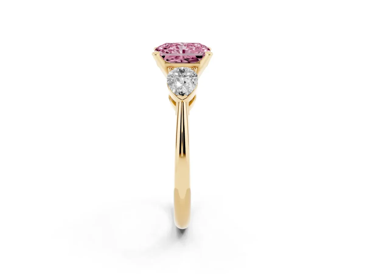 Fancy Pink Three-Stone Radiant Cut Diamond Ring with Pear Side Stones and Four-Prong Setting Yellow gold